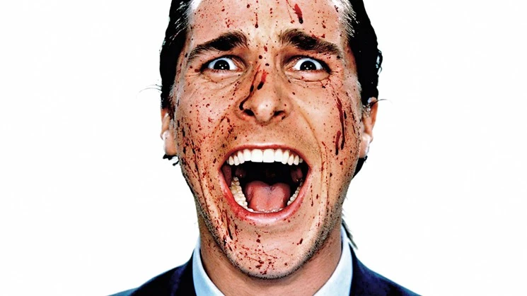 Image of Patrick Bateman screaming with a splatter of blood all over his face. You can tell that he is wearing a suit and his hair is done.